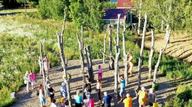 People gathered around one of the Taideakseli artworks.