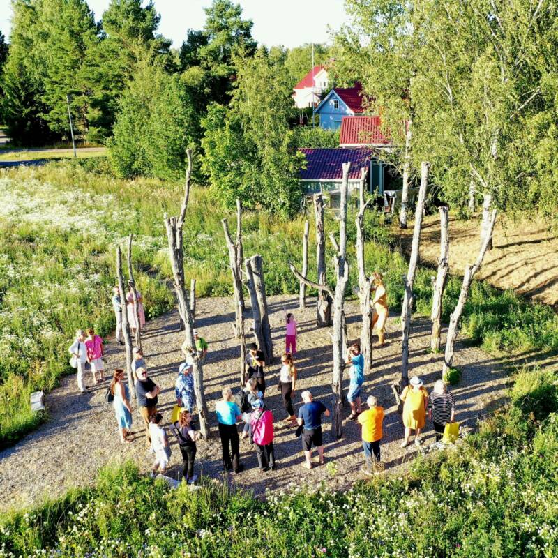 People gathered around one of the Taideakseli artworks.